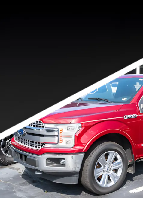 A red Ford F-150 pickup truck parked next to a black vehicle, with the top half of the image covered by a black diagonal overlay.