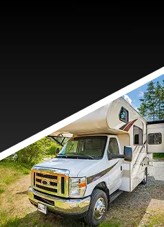 A white RV is parked on a gravel area next to grass and trees under a partly cloudy sky. The top part of the image is pixelated and blacked out.