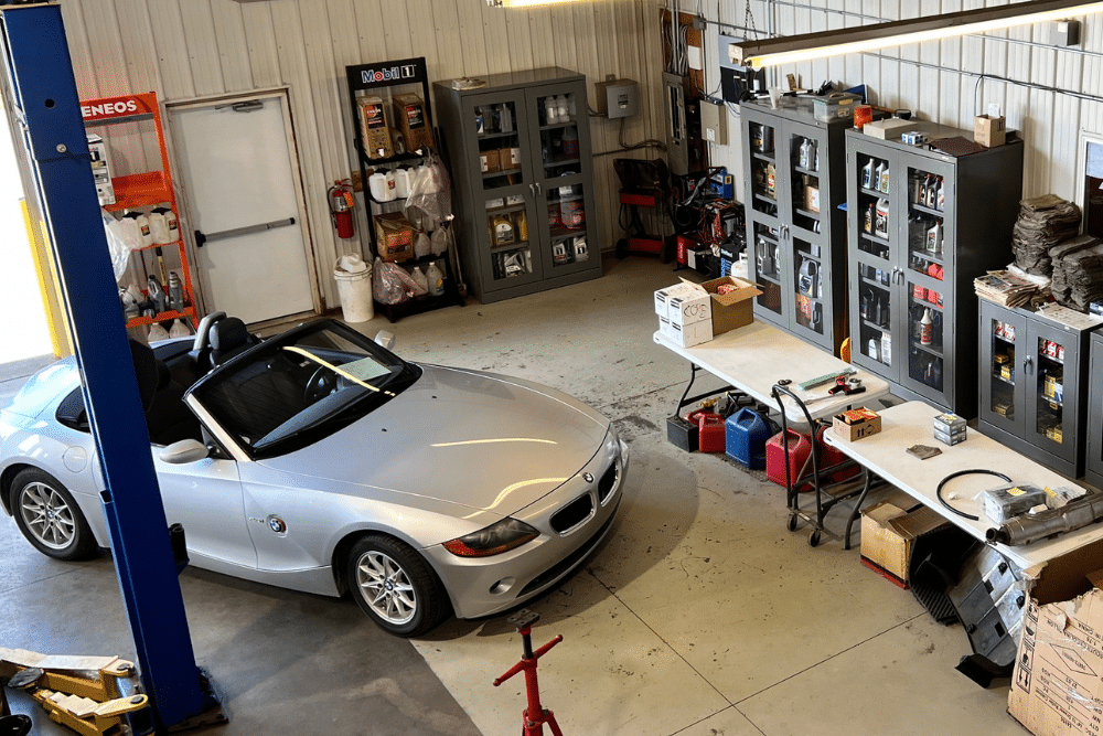 Back to School Car Maintenance near Traverse City, MI at Integrity Import Service. BMW convertible in an auto repair shop undergoing routine maintenance near Traverse City